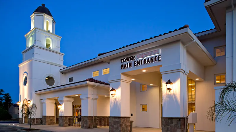 Tower main entrance of the building at 1801 Colorado Ave. in Turlock, home of Turlock Dental Studio, at dusk